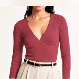 Abercrombie & Fitch Long sleeve v-neck ribbed bodysuit in the berry color.